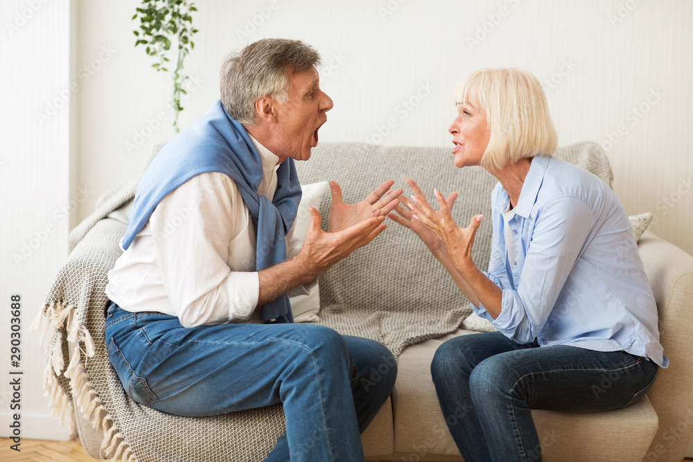 Senior couple quarrelling with each other and shouting Senior couple quarrelling with each other and shouting