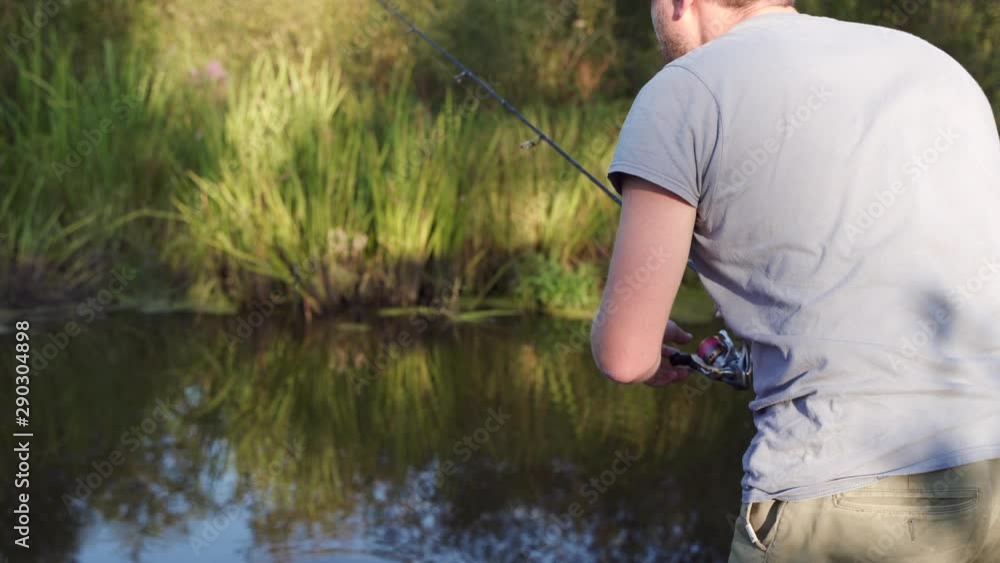 A man geek is fishing by the river and catching some computer parts. Water pollution concept. New technology idea concept. A man geek is fishing by the river and catching some computer parts. Water pollution concept. New technology idea concept.