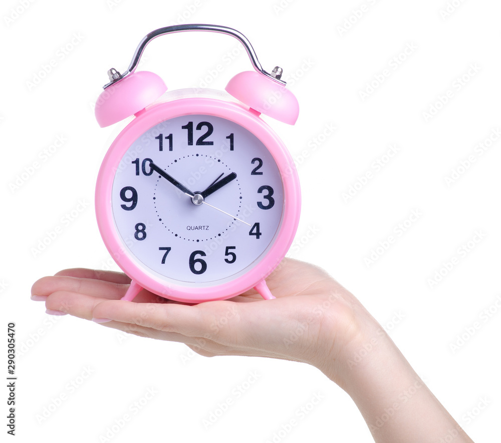 Pink alarm clock in hand on white background isolation Pink alarm clock in hand on white background isolation