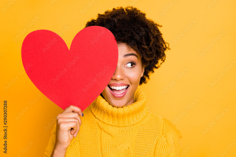 Photo of trendy cheerful cute nice charming curly fascinating girlfriend looking out away from red big heart wearing yellow jumper while isolated with bright color background - obrazy, fototapety, plakaty 