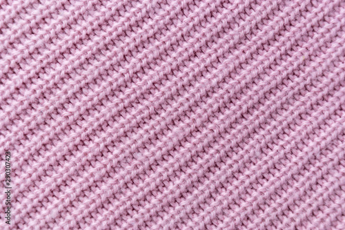 The closeup texture of pink cashmere sweater background. Macro shot of knitted fabric from Lana Wool threads