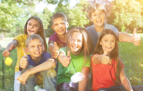 Happy smiling diverse kids hugging in park