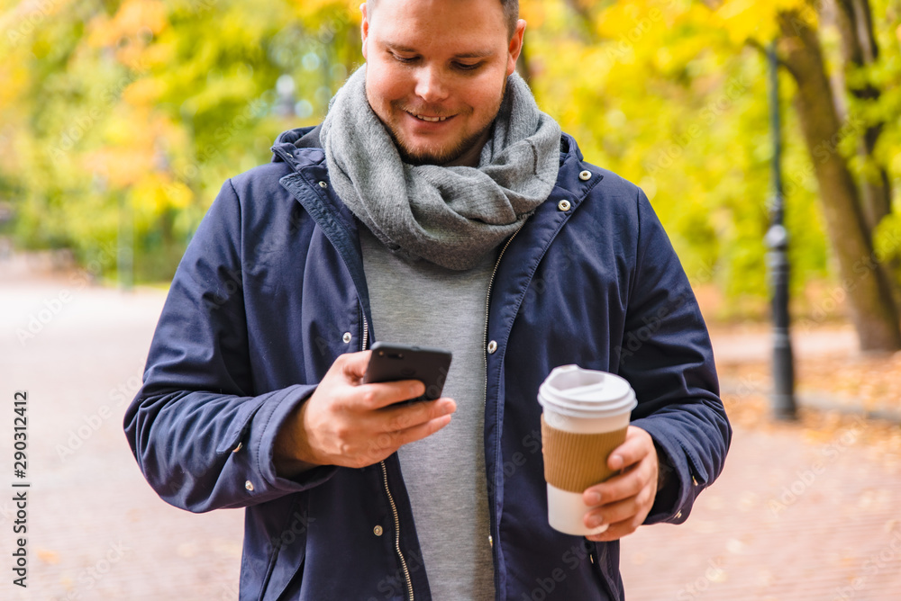 man drinking coffee outdoors autumn season talking on the phone man drinking coffee outdoors autumn season talking on the phone