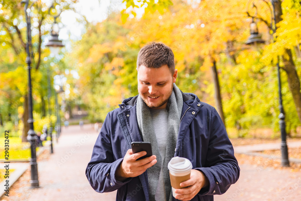 man drinking coffee outdoors autumn season talking on the phone man drinking coffee outdoors autumn season talking on the phone