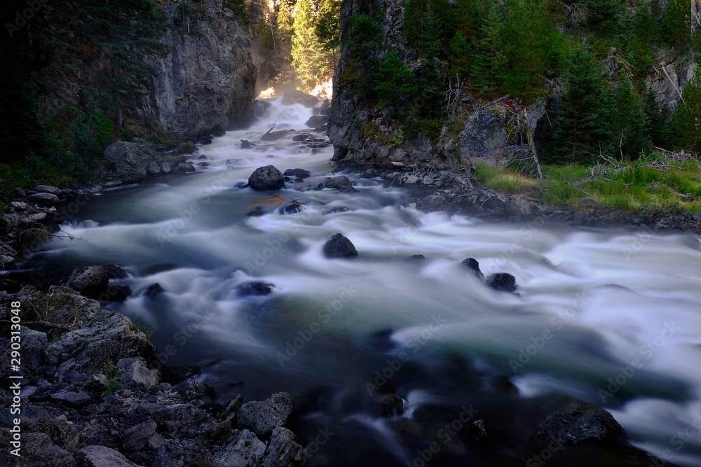 River in Wilderness Mountains Cascading Down Rocks in Riverbed River in Wilderness Mountains Cascading Down Rocks in Riverbed
