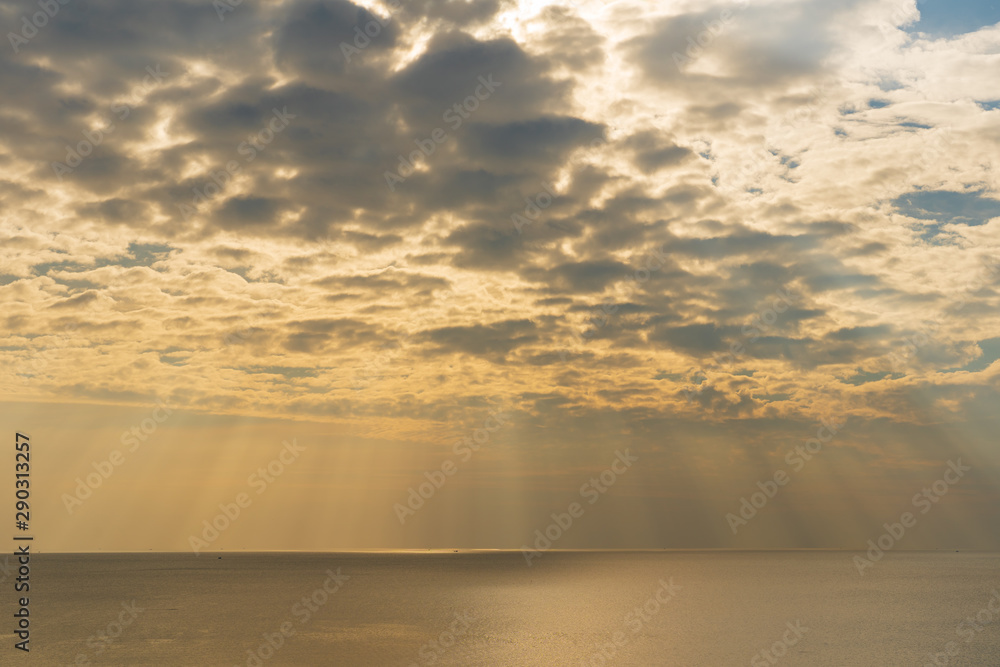 Sun light through the sky blast over the sea Sun light through the sky blast over the sea