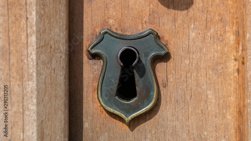 oxidized lock on medieval wooden door photo