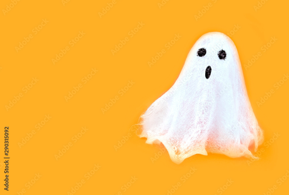 Halloween white spooky ghost spirit on orange backgrounds. Minimal concept scary autumn. - obrazy, fototapety, plakaty 