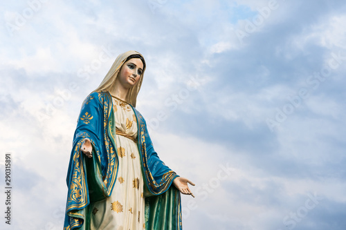 The Blessed Virgin Mary,mother of Jesus on the blue sky, in front of the Roman Catholic Diocese, public place in Chanthaburi, Thailand.