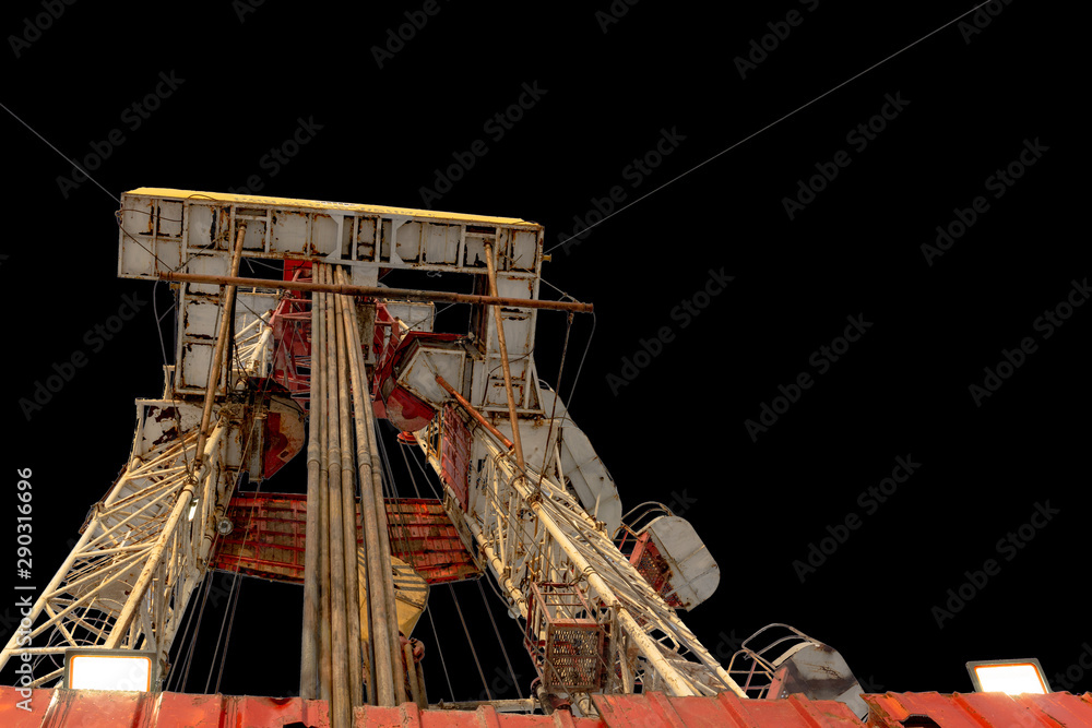 Oil and Gas Drilling Rig. Oil platform isolated on black background. Drilling rig in oil field for drilled into subsurface in order to produced crude, inside view. Petroleum Industry.