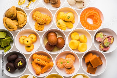 Rangoli of Assorted Indian sweets/mithai in bowl for Diwali or any other festivals, selective focus photo