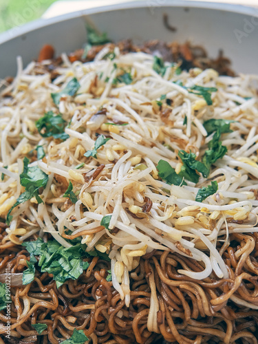 bean sprouts and noodles served in a bowl and viewed from above. you can see the fresh ingredients