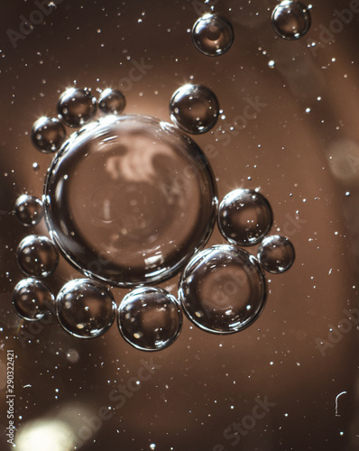 transparent bubbles on a brown background close-up