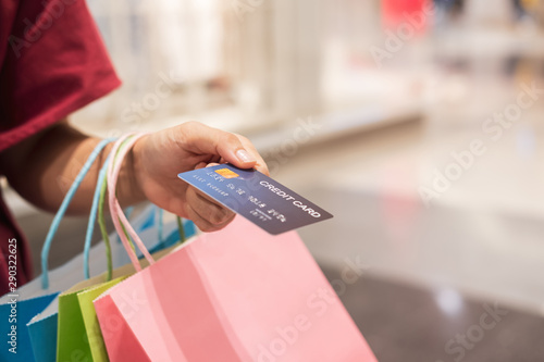 happy young asian woman holding credit card and colorful shopping bags, Woman lifestyle concept.