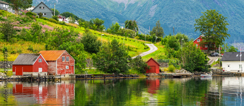 Norwegian rural wooden houses green coast of fjord, landscape sea view, Norway, Rosendal. photo