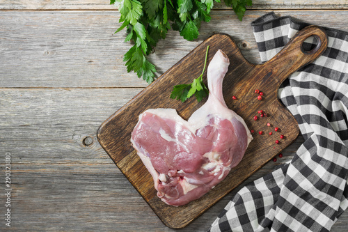 Raw duck meat on a chopping Board on a gray table. Top view. Place for text
