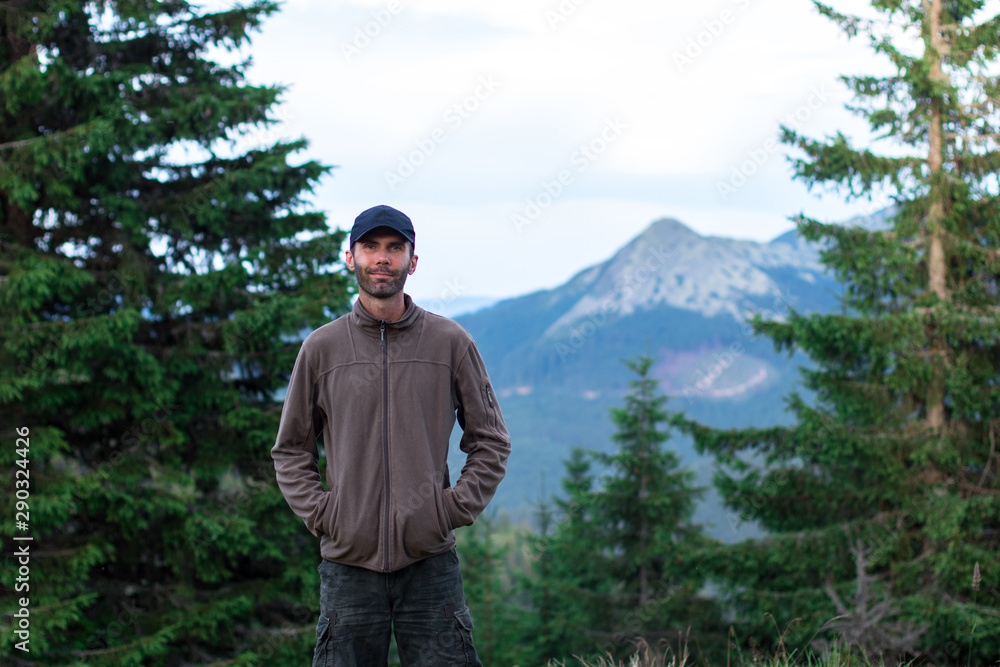 hiker man in cap admires the scenery of mountain range in the carpathian mountains gorgany hiker man in cap admires the scenery of mountain range in the carpathian mountains gorgany