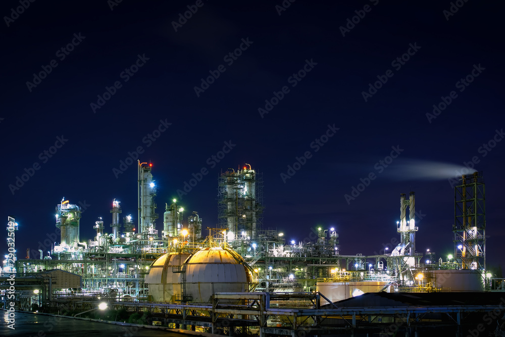 Glitter lighting of petrochemical plant at night, Manufacturing of petroleum industrial plant with twilight sky background, Oil and gas refinery plant