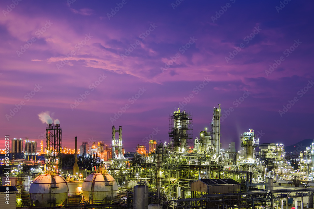Oil and gas refinery plant or petrochemical industry on sky sunset background, Gas storage sphere tank and distillation tower in petroleum industrial