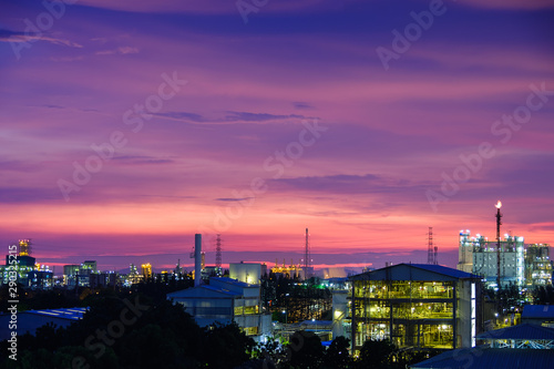 Sunset sky view with petrochemical industry estate, glitter lighting factory of petroleum industrial plant on sky sunset background