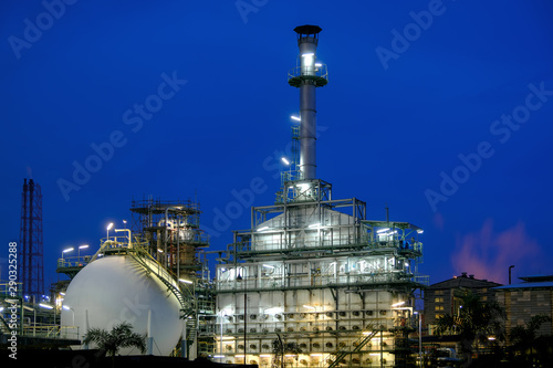 Oil and gas refinery plant or Petrochemical industrial plant on blue sky twilight background, Factory of petroleum with dawn sky, Industrial furnace and smoke stack cracked hydrocarbon chain
