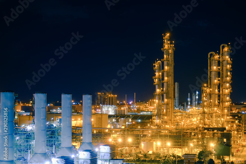 Glitter lighting of distillation tower and smoke stacks of power plant at night, Manufacturing of petrochemical plant, Factory of Olefins plant photo