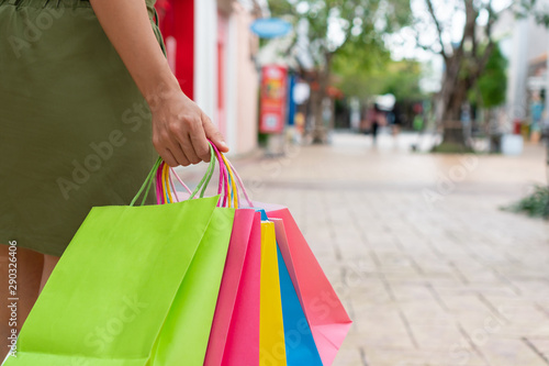 Concept of happy woman shopping and holding bags, closeup images.