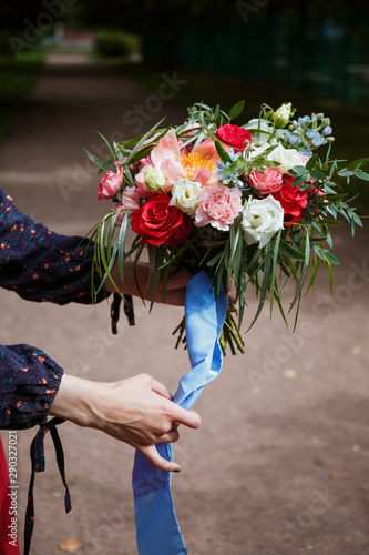 Florist girl collects a large beautiful bouquet. Floristic concept, business concept, gift, surprise, peonies, roses, carnations