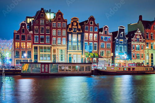 Traditional buildings in Amsterdam at night.