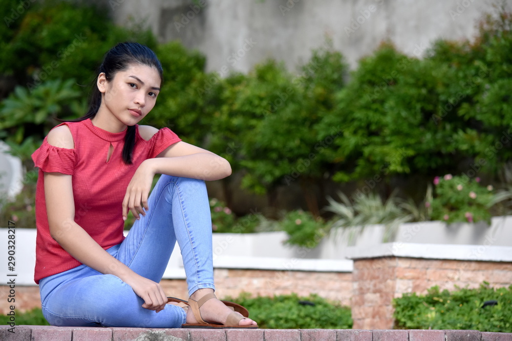 Naklejka premium A Beautiful Female Youngster Sitting