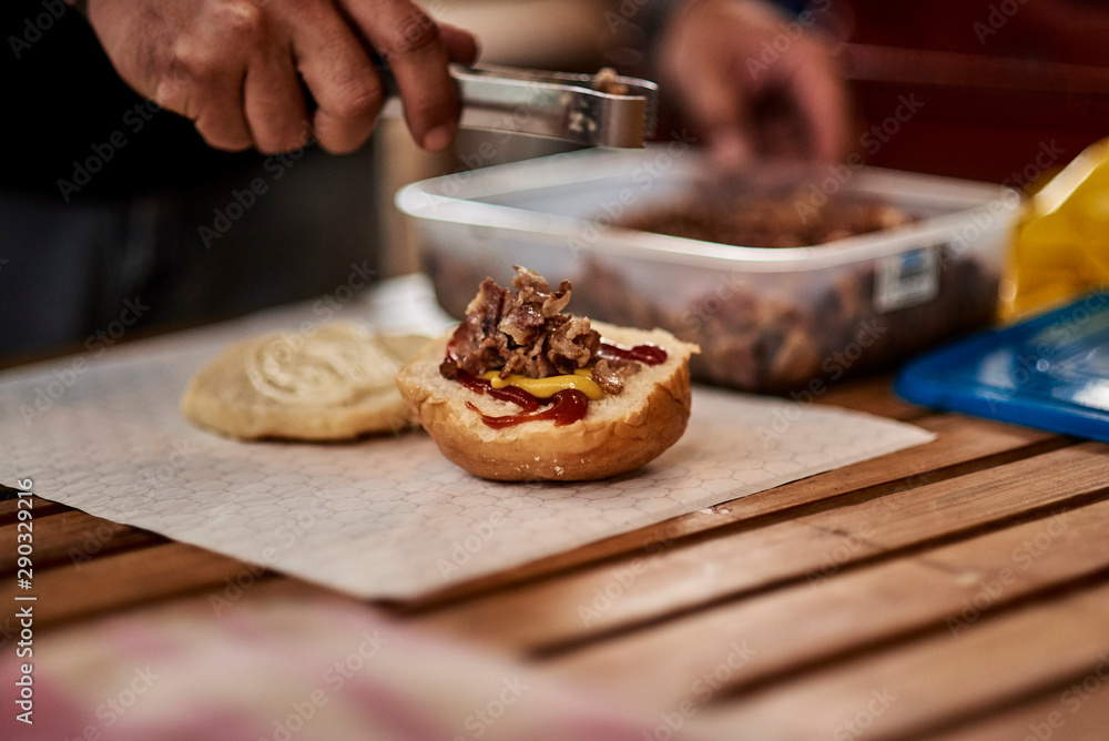 hamburger being prepared on a table