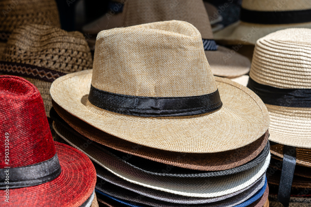 Straw hats on display for sale to tourists on street local market in Ubud, island Bali, Indonesia, closeup