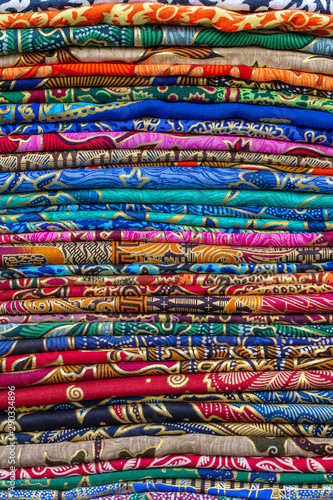 Assortment of colorful sarongs for sale in local market on tropical island Bali, Indonesia.