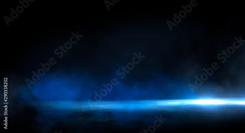 Blue dark background of empty foggy street with wet asphalt, illuminated by a searchlight, laser beams, smoke