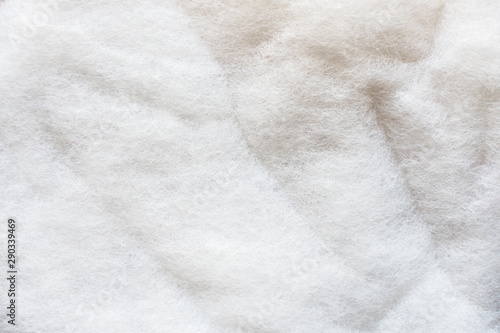 The texture of a white padding polyester. Syntepon- insulation material for clothes