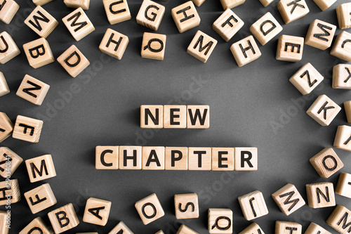 Foto new chapter - words from wooden blocks with letters, starting new life new chapt
