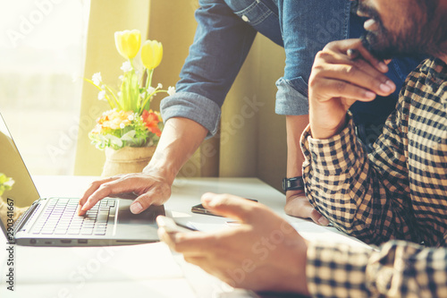 Business meeting time. Photo young account managers crew working with new startup project. Notebook on white table. Idea presentation, analyze plans.