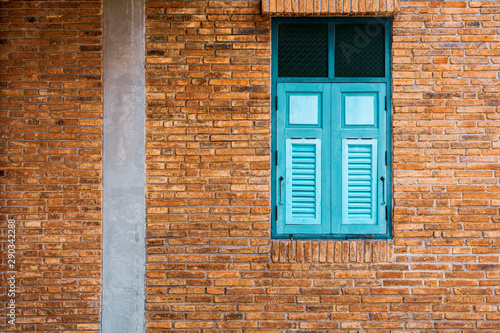 classic green and blue wood window at the antique brick building.