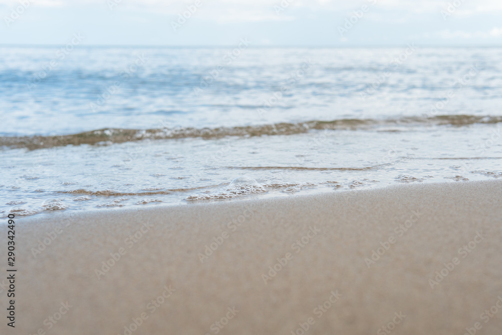 Beautiful waves rolling up on a sandy beach. Summertime in Österlen, Sweden. Beautiful waves rolling up on a sandy beach. Summertime in Österlen, Sweden.