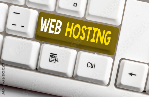 Conceptual hand writing showing Web Hosting. Concept meaning The activity of providing storage space and access for websites White pc keyboard with note paper above the white background