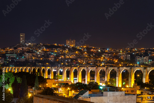 Cityscape of Queretaro city at night with its famous Viaduct, Mexico. photo