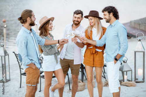 Sticker Group of young friends having fun, hanging out together with wine glasses during