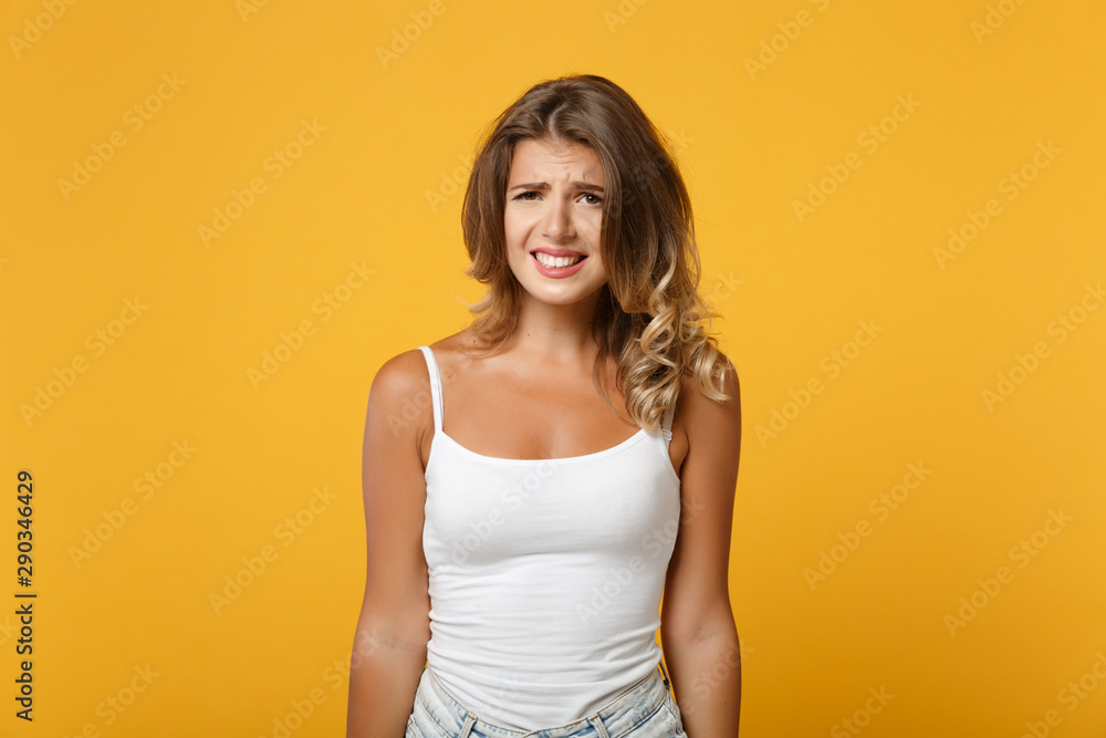 Perplexed young woman girl in light casual clothes posing isolated on yellow orange wall background studio portrait. People sincere emotions lifestyle concept. Mock up copy space. Looking camera. Perplexed young woman girl in light casual clothes posing isolated on yellow orange wall background studio portrait. People sincere emotions lifestyle concept. Mock up copy space. Looking camera.