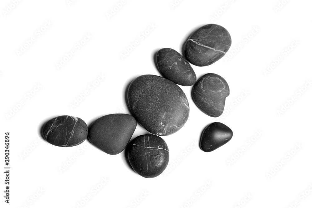 Scattered sea pebbles. Heap of smooth gray and black spa stones isolated on white background Scattered sea pebbles. Heap of smooth gray and black spa stones isolated on white background