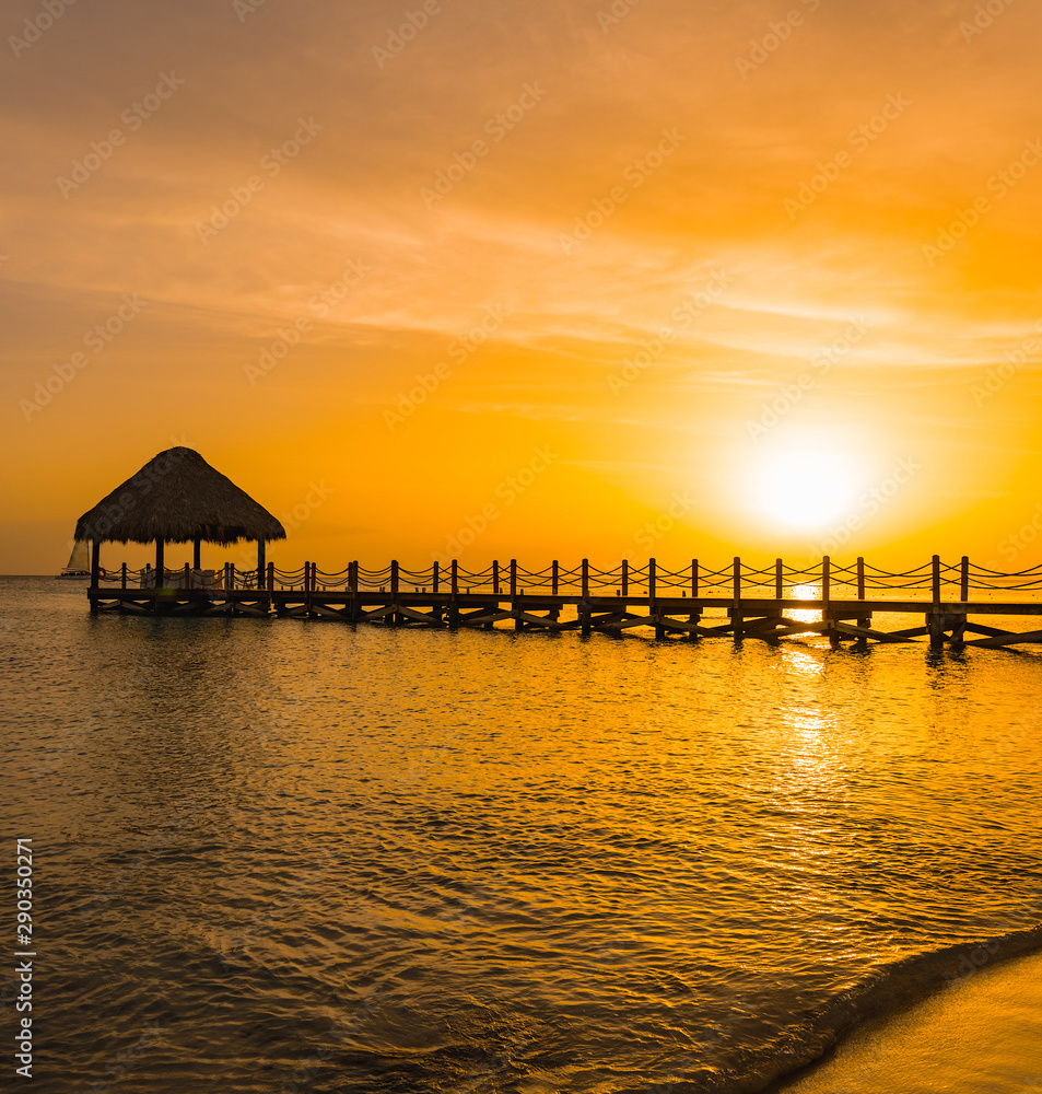 beautiful orange sunset on the sea with a pier