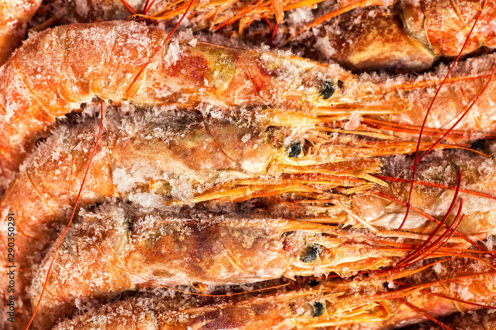 Fresh red shrimps or prawn packing in box on slate stone background. Seafood, top view, flat lay, copy space Fresh red shrimps or prawn packing in box on slate stone background. Seafood, top view, flat lay, copy space