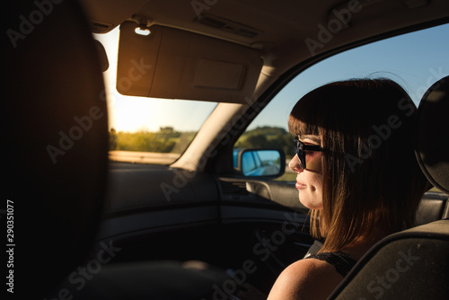 A young and attractive girl with piercings travels by car with sunglasses. © Alberto