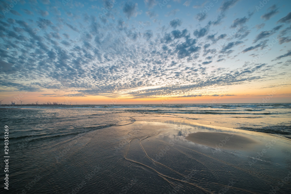 Fototapeta premium Beautiful landscape image of sheep clouds and twilight colors in the sky at sea