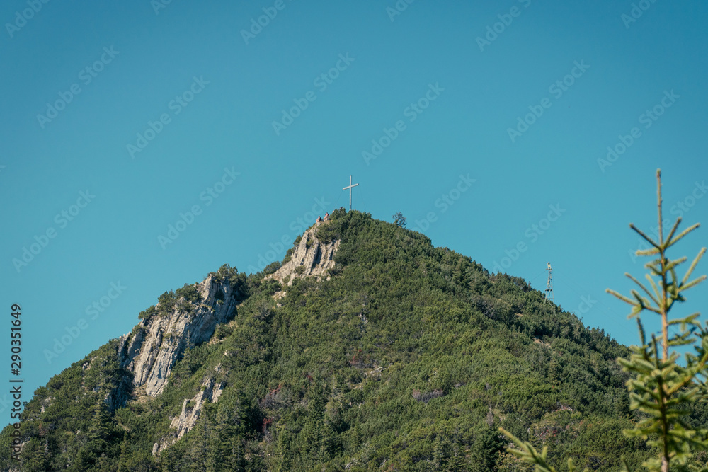 View of the cross on top of the Heimgarten mountain over lake Walchen in Bayern, Germany View of the cross on top of the Heimgarten mountain over lake Walchen in Bayern, Germany