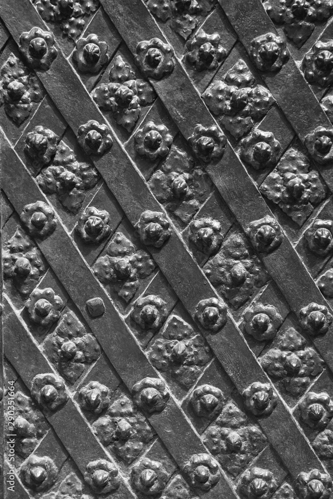 Black forged door, rhombus symmetrical texture Black forged door, rhombus symmetrical texture